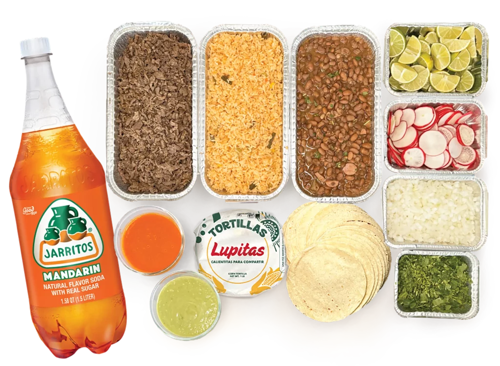 Taco bar with soda, tortillas, beans and more